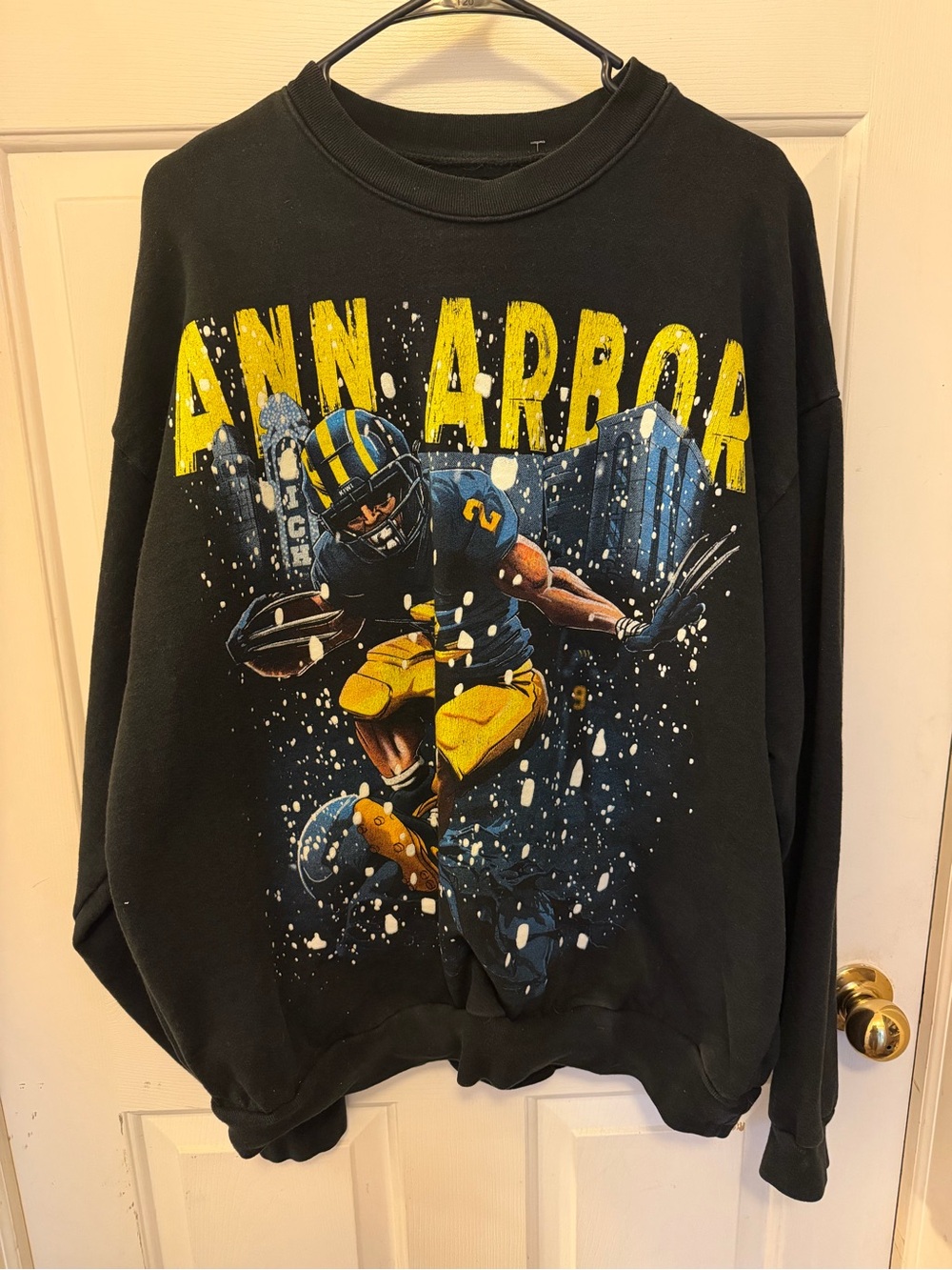 Kiwi Black Crewneck Sweatshirt with Yellow & Blue Football Graphic
